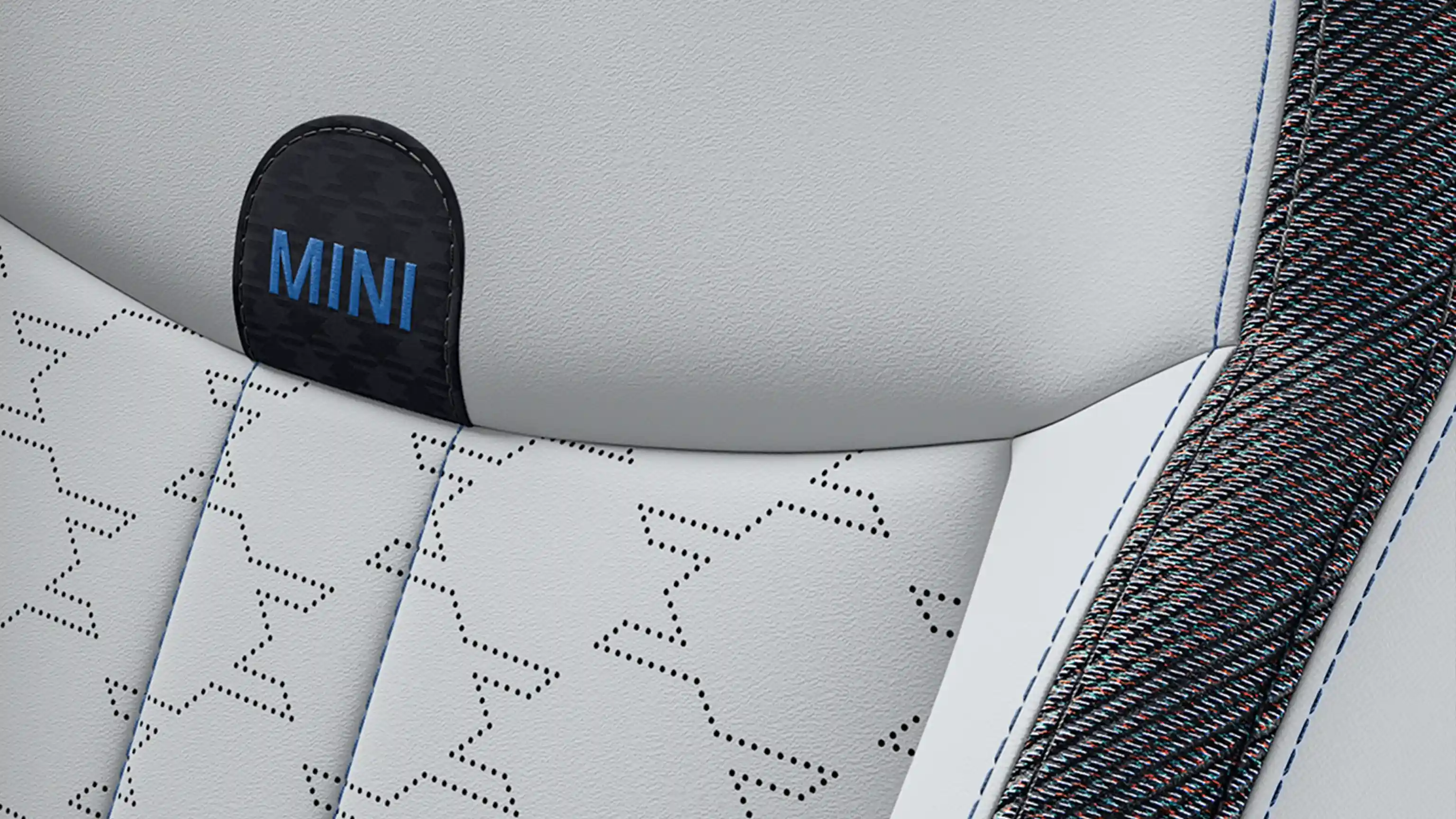 Az 5 ajtós MINI Cooper Classic Style belső nézete a Vescin/szövet szürke/kék kárpitozott ülésekkel