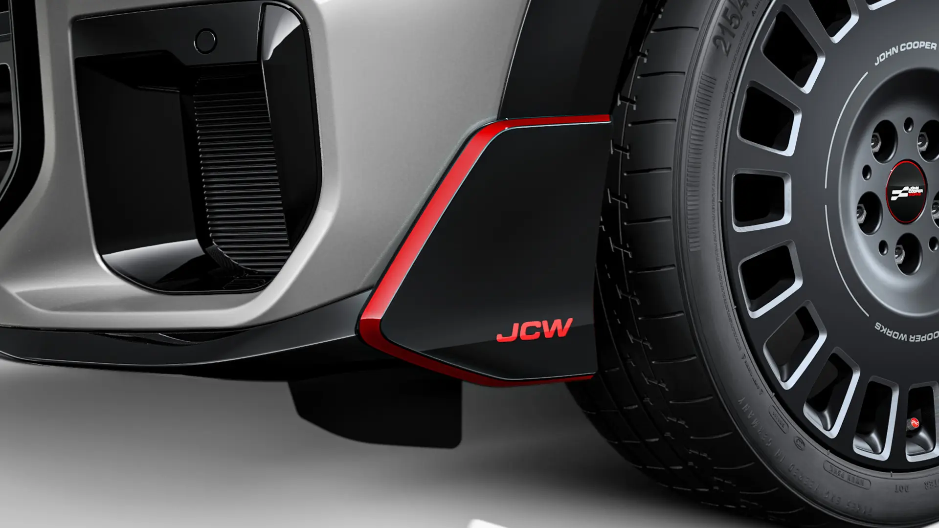 MINI John Cooper Works magasfényű fekete első szárnytoldat piros JCW betűkkel és dekorcsíkokkal.